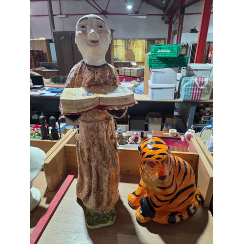 633 - A paper mache monk and tiger together with a wooden figure on crucifix and a figure on horseback wit... 