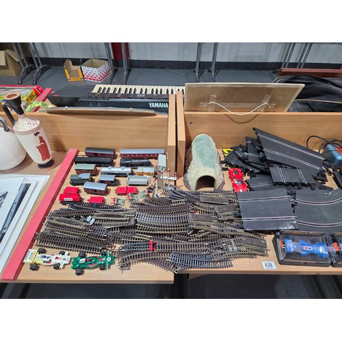 638 - A Scalextric set together with model railway track, carriages, trains, etc