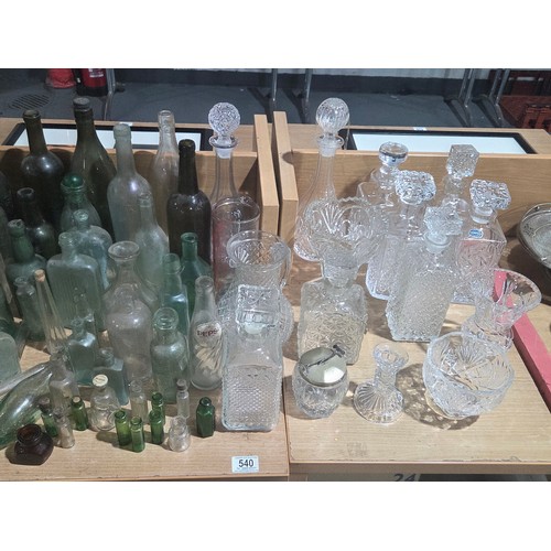 540 - A collection of old bottles together with cut glass decanters vases etc