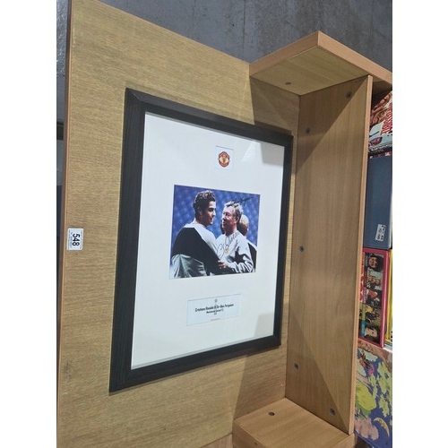 548 - A framed signed photograph of Manchester United F.C football player Cristiano Ronaldo and Sir Alex F... 