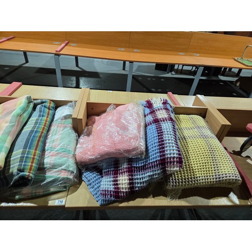 710 - Seven woollen and waffle blankets