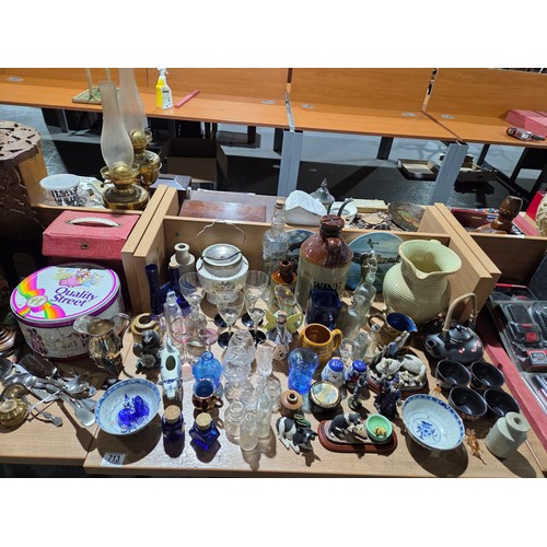 713 - A carved folding side table, mantle clock, stoneware jug, ornaments, etc