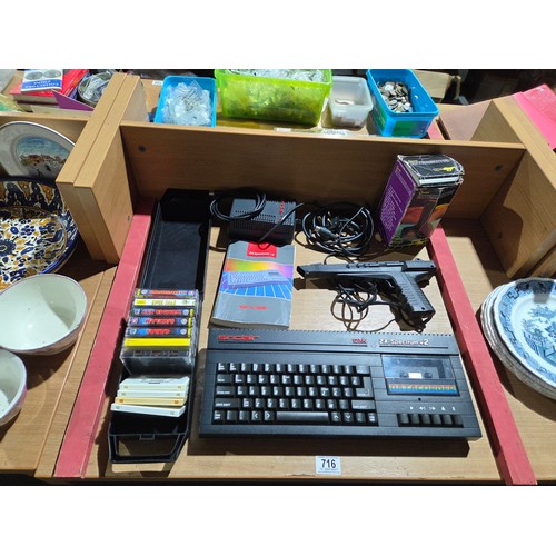 716 - A Sinclair ZX Spectrum+2 home computer with manual, charger, accessories and an assortment of games