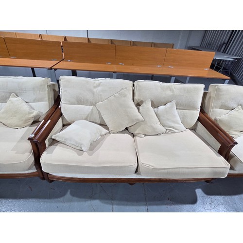 813 - An Ercol two seater sofa and two armchairs