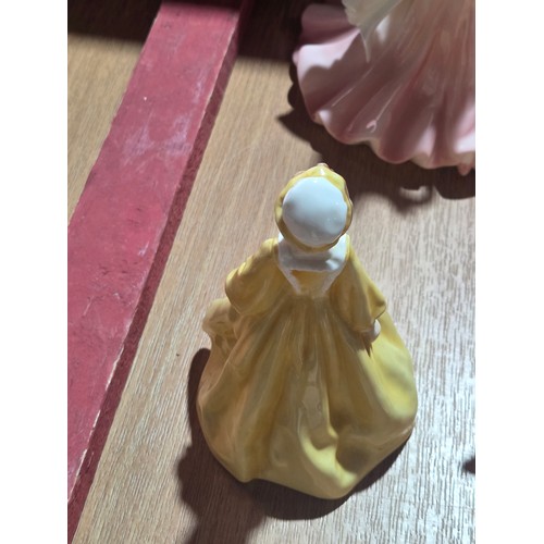 519 - A collection of Royal Doulton, Royal Worcester and Coalport figurines of varying sizes