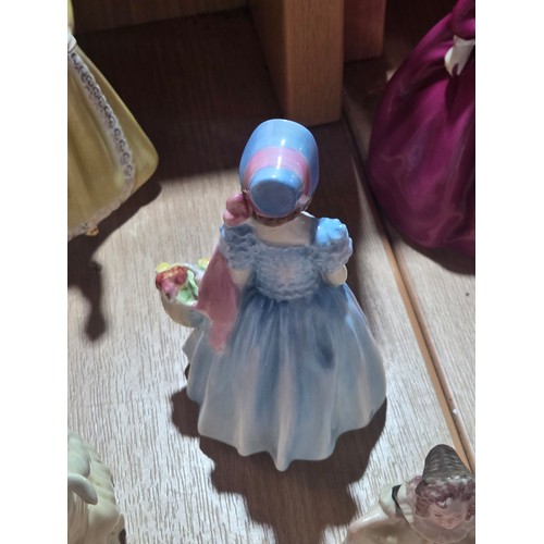 519 - A collection of Royal Doulton, Royal Worcester and Coalport figurines of varying sizes