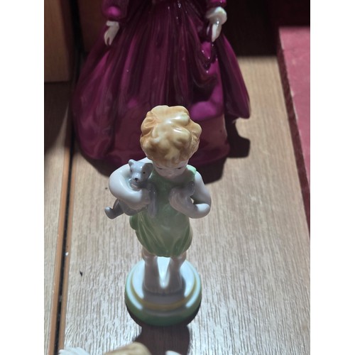519 - A collection of Royal Doulton, Royal Worcester and Coalport figurines of varying sizes