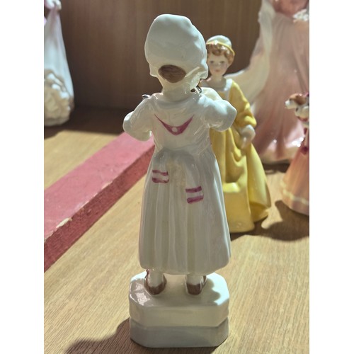 519 - A collection of Royal Doulton, Royal Worcester and Coalport figurines of varying sizes