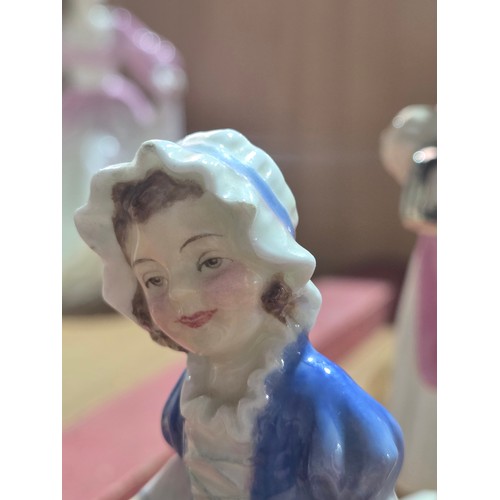 519 - A collection of Royal Doulton, Royal Worcester and Coalport figurines of varying sizes