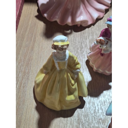519 - A collection of Royal Doulton, Royal Worcester and Coalport figurines of varying sizes