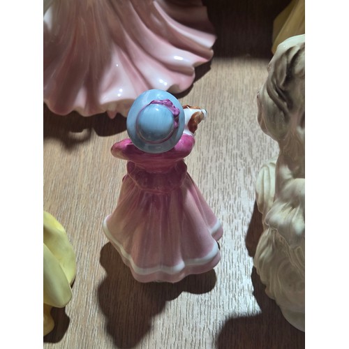 519 - A collection of Royal Doulton, Royal Worcester and Coalport figurines of varying sizes