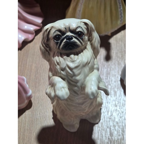 519 - A collection of Royal Doulton, Royal Worcester and Coalport figurines of varying sizes