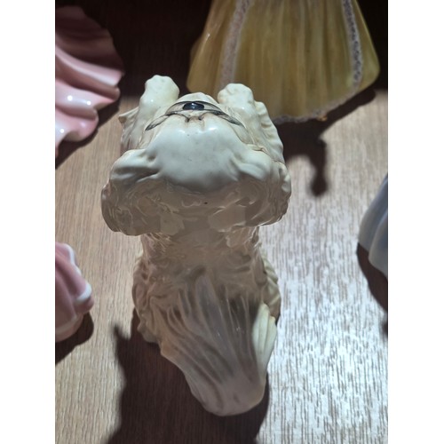 519 - A collection of Royal Doulton, Royal Worcester and Coalport figurines of varying sizes