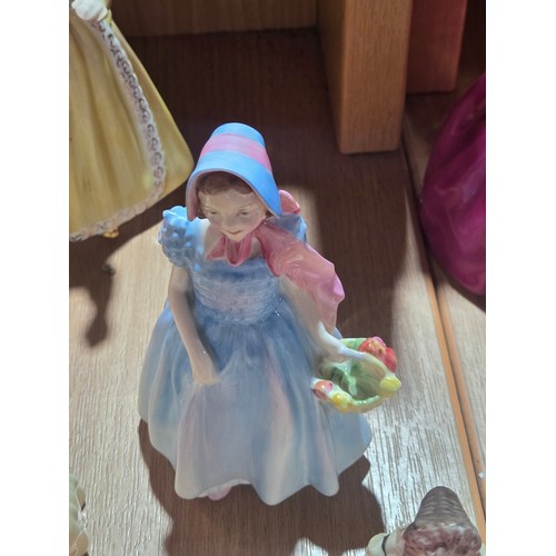 519 - A collection of Royal Doulton, Royal Worcester and Coalport figurines of varying sizes