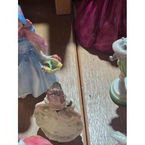 519 - A collection of Royal Doulton, Royal Worcester and Coalport figurines of varying sizes
