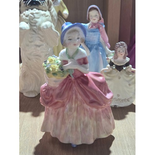 519 - A collection of Royal Doulton, Royal Worcester and Coalport figurines of varying sizes