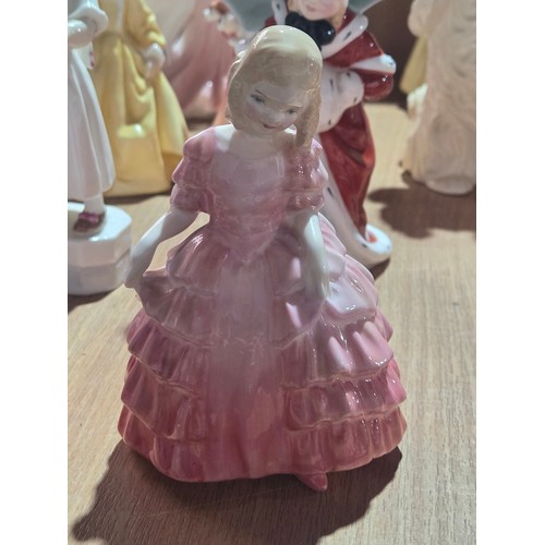 519 - A collection of Royal Doulton, Royal Worcester and Coalport figurines of varying sizes