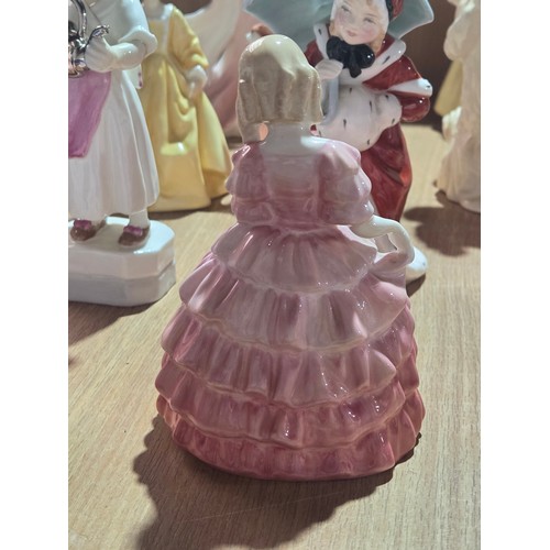 519 - A collection of Royal Doulton, Royal Worcester and Coalport figurines of varying sizes