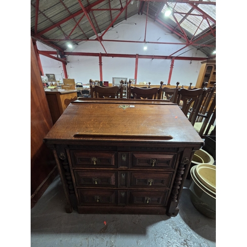 435 - An oak bureau/desk with unusual fold down supports, fitted interior above three drawers measurements... 