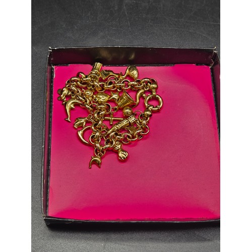 507 - A 9k gold charm bracelet with charms - weight 16 grams