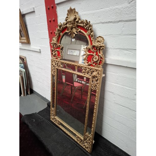 477 - A regency large giltwood  and plaster mirror, very ornate with parclose mirror plate, the top featur... 