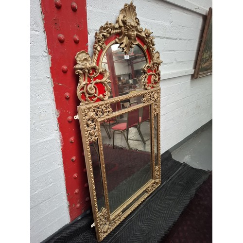 477 - A regency large giltwood  and plaster mirror, very ornate with parclose mirror plate, the top featur... 