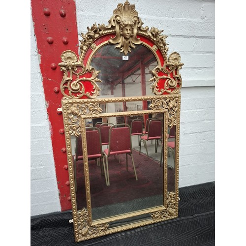 477 - A regency large giltwood  and plaster mirror, very ornate with parclose mirror plate, the top featur... 