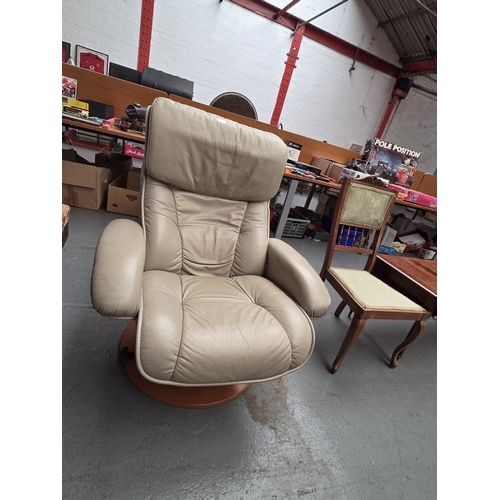 506 - A cream leather swivel armchair