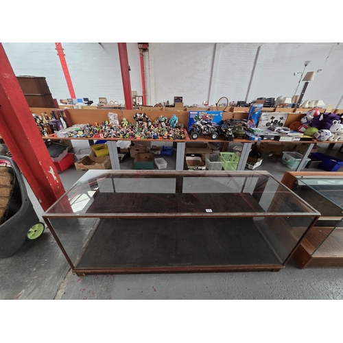 510 - A large glazed shop display counter

Height 75cm, width 184cm, depth 60cm