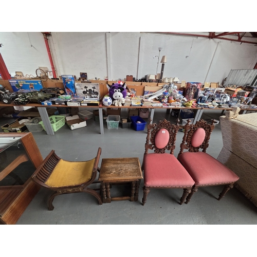 512 - A pair of carved hall chairs, nest of tables and a mahogany cradle stool