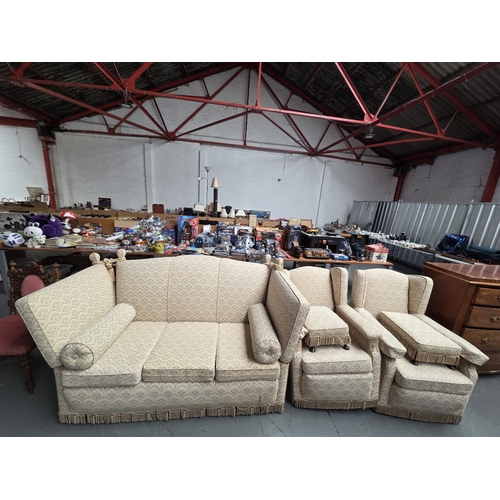 513 - A Knoll drop arm three seater sofa with two matching armchairs and footstools