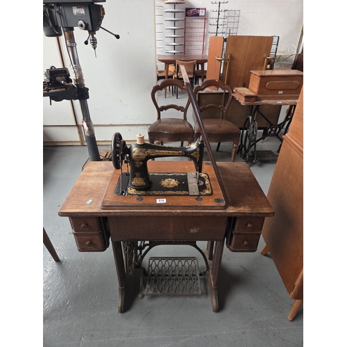 518 - A Singer sewing machine with treadle