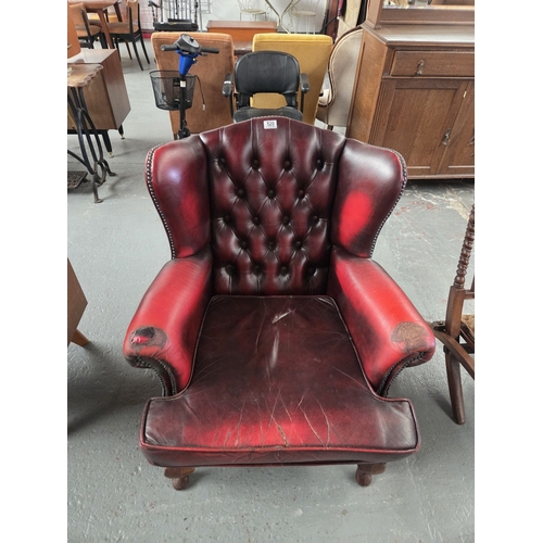 520 - A red leather Chesterfield wingback armchair