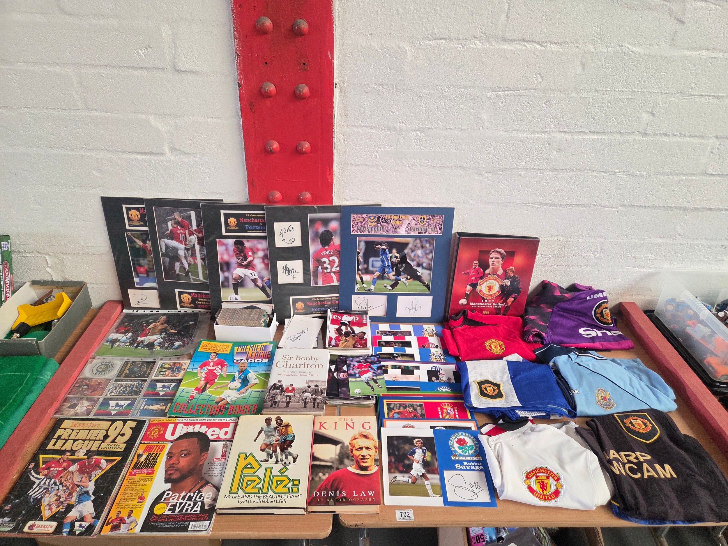 A selection of football memorabilia to include shirts, cards, books ...