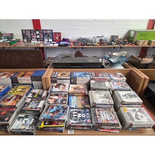 719 - A Playstation 2 and Playstation 3 console (no controllers or leads) with an assortment of Playstatio... 