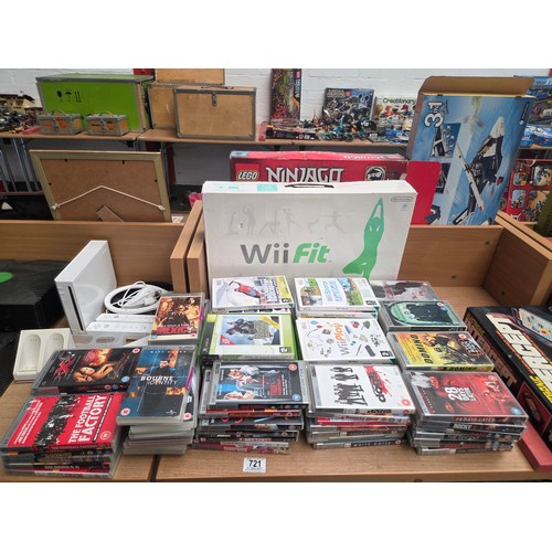 721 - An XBox and XBox 360 console, Nintendo Wii console with accessories and an assortment of Wii, XBox a... 