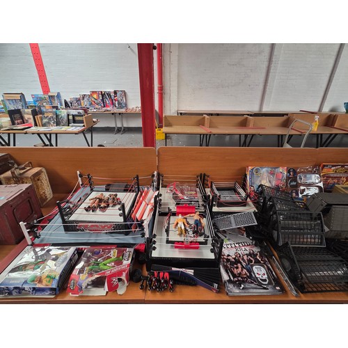 746 - A large quantity of wrestling items to include figures, wrestling rings, books, accessories etc.