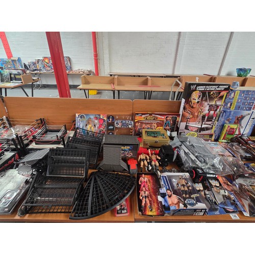 746 - A large quantity of wrestling items to include figures, wrestling rings, books, accessories etc.