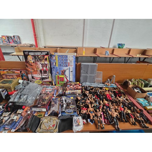746 - A large quantity of wrestling items to include figures, wrestling rings, books, accessories etc.