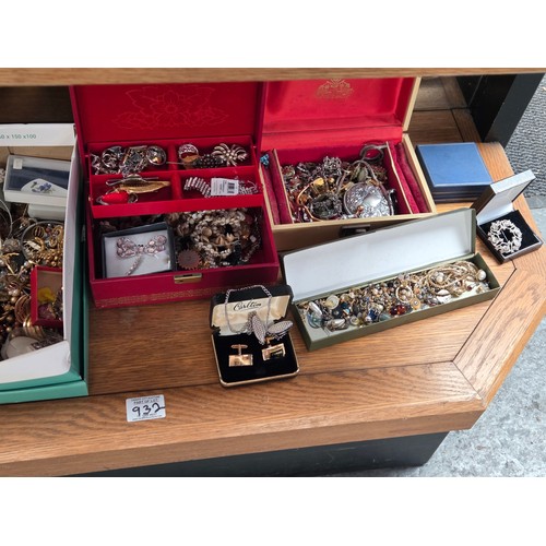 932 - A quantity of costume jewellery displayed over three shelves
