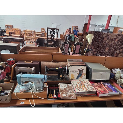 639 - A collection of vintage items to include clocks, sewing machines, vinyl LP's, badges, 2 hand carved ... 