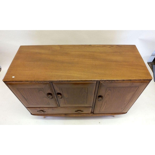 1160 - A retro Ercol elm sideboard with three cupboards and a drawer, cutlery drawer within