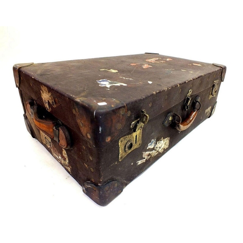 1179 - An early 20th century large suitcase with leather mounts