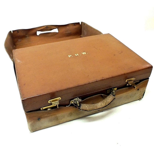 1201 - An early 20th century pigskin suitcase with canvas cover