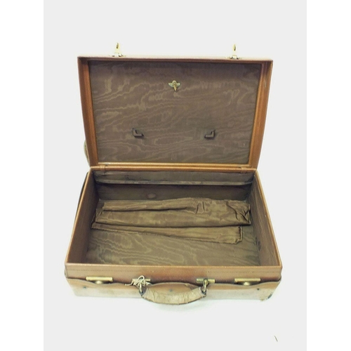 1201 - An early 20th century pigskin suitcase with canvas cover