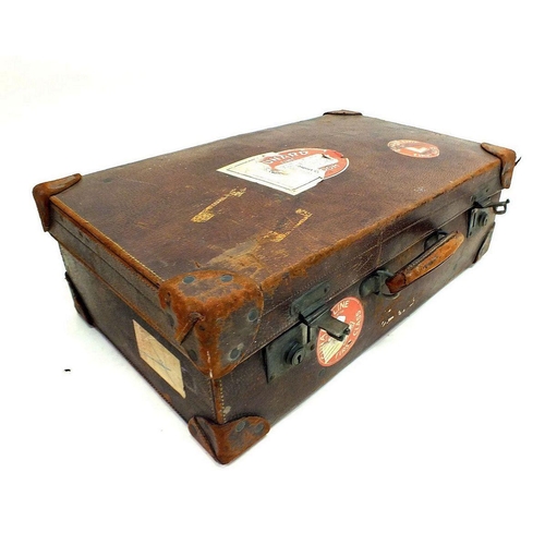 1202 - An early 20th century leather suitcase with Cunard Line labels