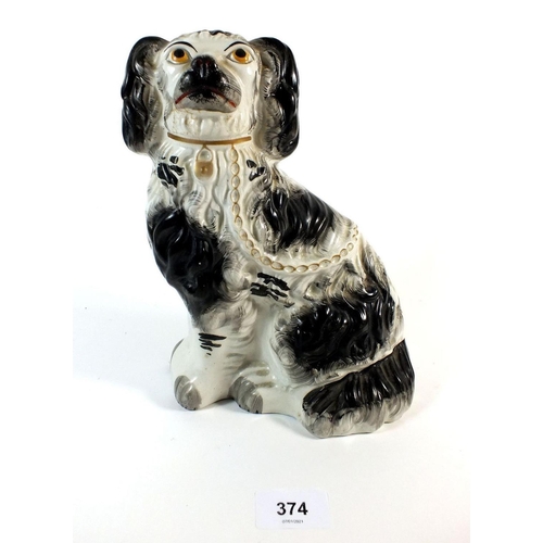 374 - A 19thC Staffordshire black and white spaniel figure, 24cm.