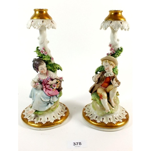 378 - A pair of Capodimonte candlesticks with seated boy and girl, 25cm tall