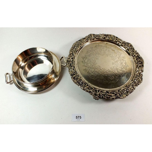 575 - An Elkington and Co. silver plated holder together with a silver plated salver with rococo edge deco... 