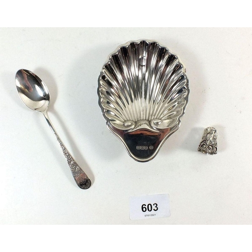 603 - A silver shell form dish, Victorian silver teaspoon with embossed design and a decorative silver thi... 